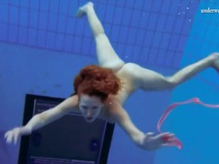Free Kilo Movies presents: Curly hair redhead swims and looks sexy